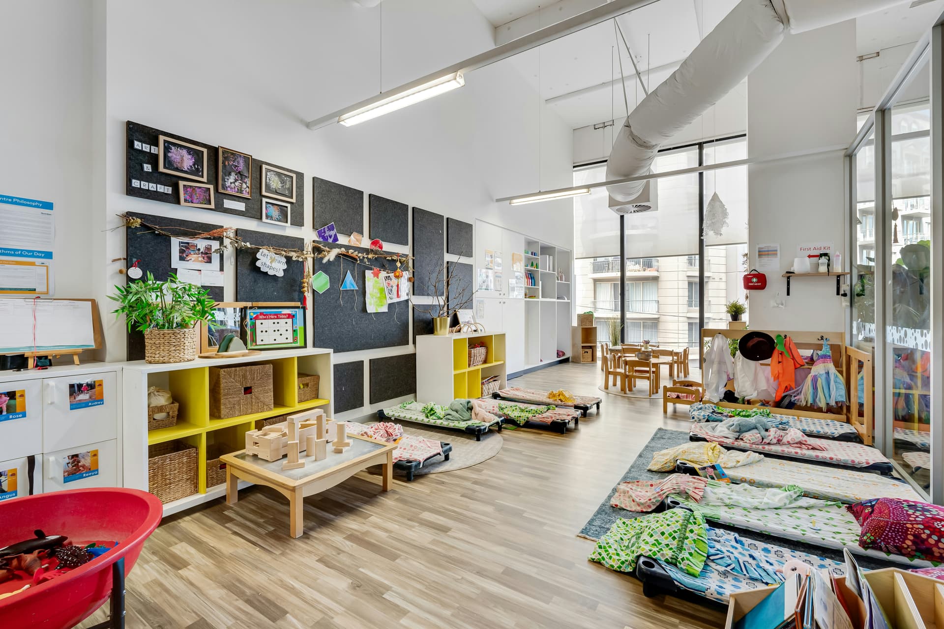 A bright, organized childcare classroom with cubbies and learning materials
