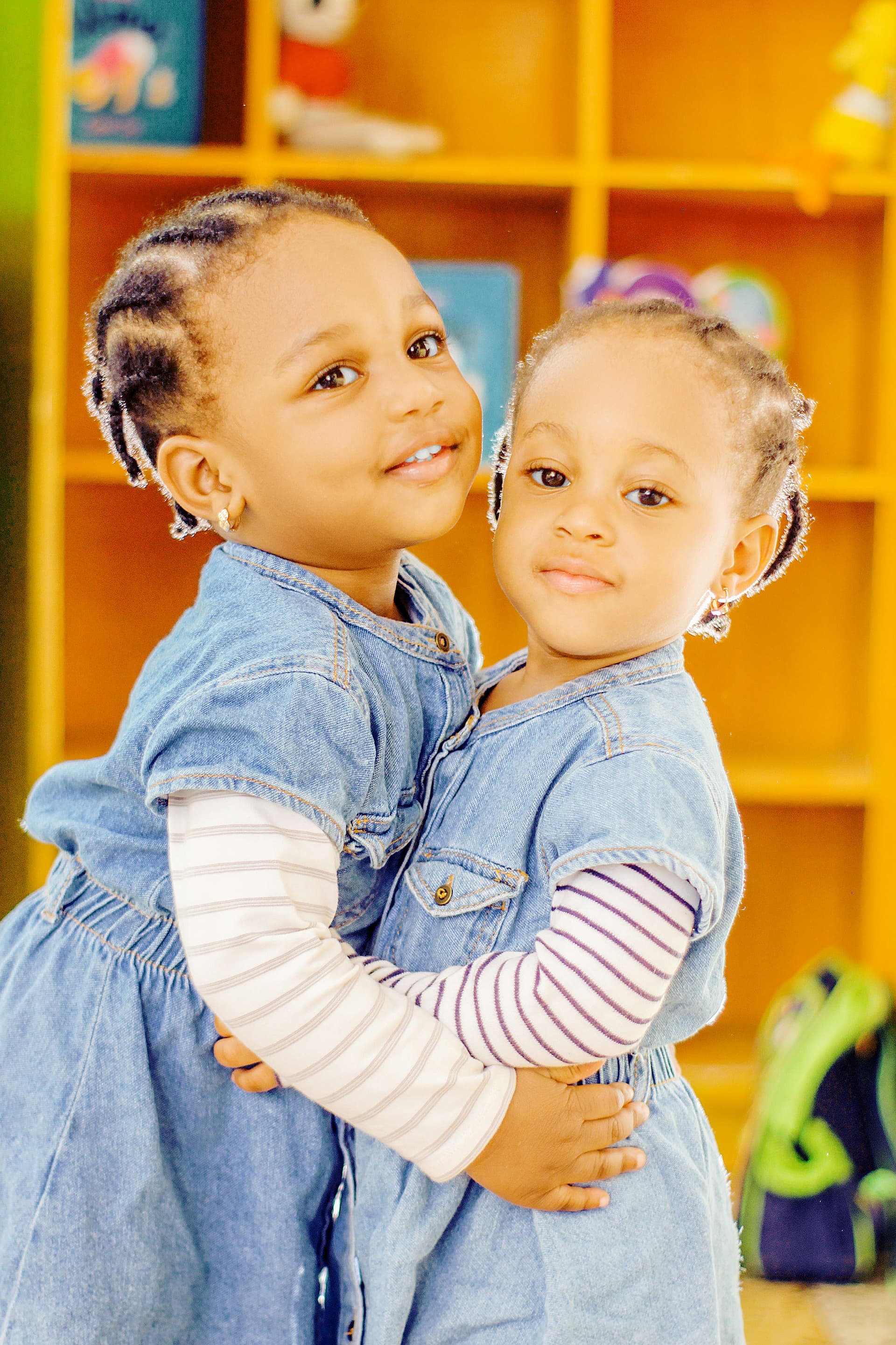 Two young children hugging in a childcare center